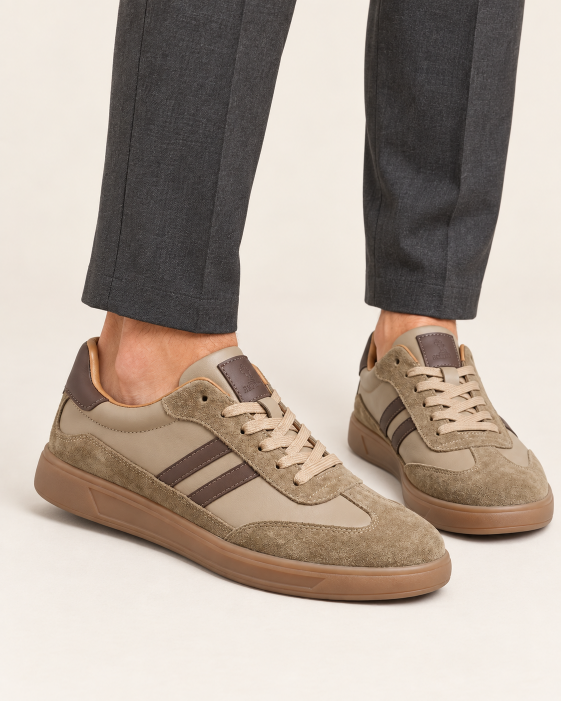 Men's Retro Leather and Suede Court Trainers with Gum Sole in Taupe, worn with trousers