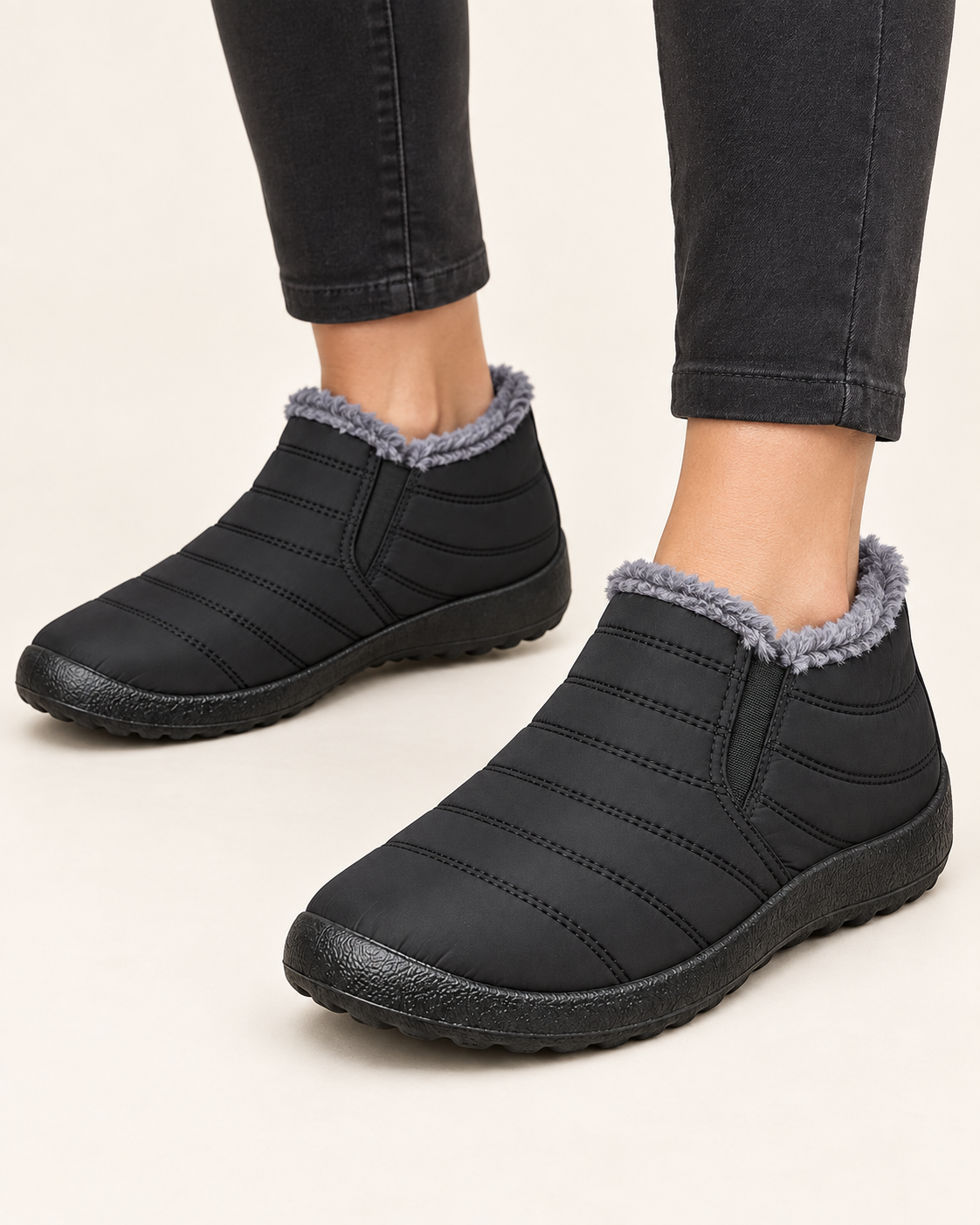 Women's Fleece Lined Slip On Winter Ankle Boots in Black, on model
