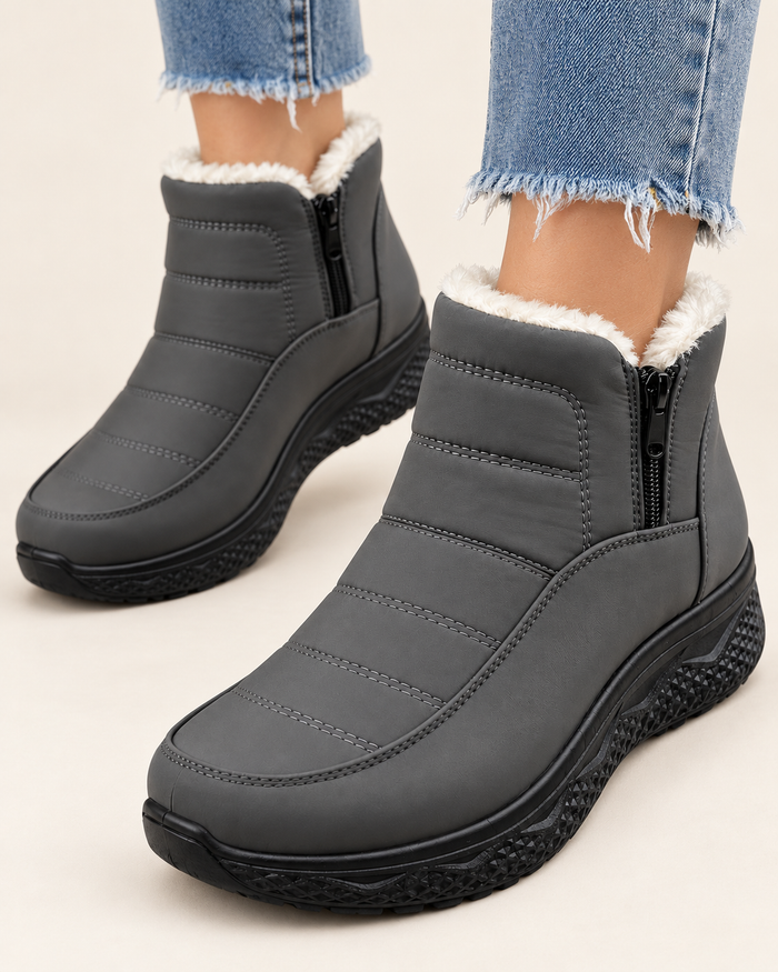 Women's Plush Lined Quilted Ankle Boots with Front Zip in Grey, on model